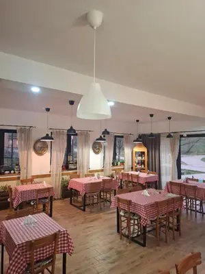 a restaurant with red and white tables and chairs at Fruškogorski Đeram in Grgeteg
