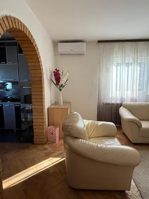 a living room with a white couch and a chair at Kares house in Belgrade