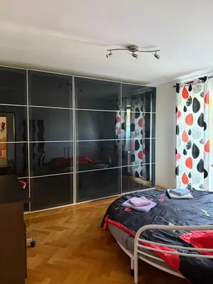 a bedroom with a bed and a glass wall at Kares house in Belgrade