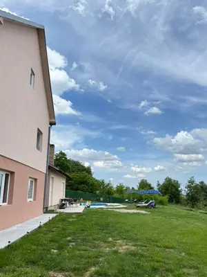 a building with a grassy yard next to a building at Kares house in Belgrade