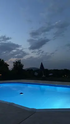 a large blue swimming pool at night at Kares house in Belgrade