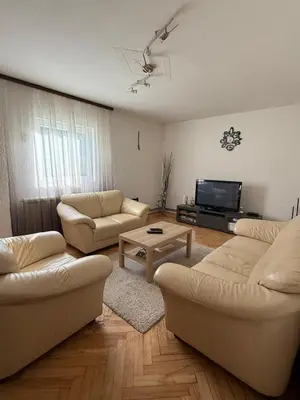 a living room with two couches and a tv at Kares house in Belgrade