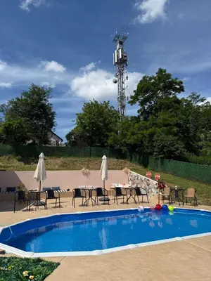 a swimming pool with a table and chairs and a table and chairsktop at Kares house in Belgrade