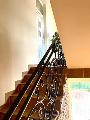 a staircase with a wrought iron railing and a door at Amazing Memories in Belgrade
