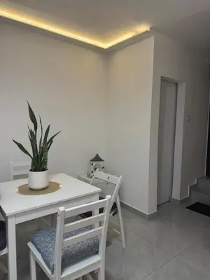 a dining room with a table and a potted plant at Alexandar13 in Belgrade