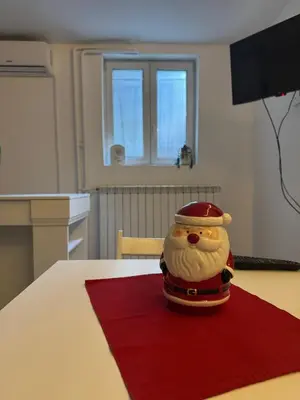 a santa claus figurine sitting on top of a table at Alexandar13 in Belgrade
