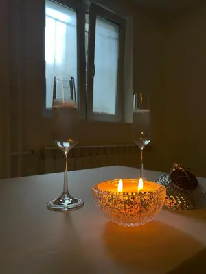 two glasses of wine and a candle on a table at Alexandar13 in Belgrade