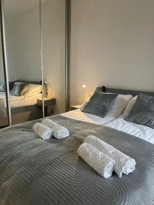 two white towels on a bed in a bedroom at Iskra in Karaburma