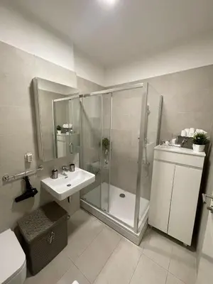 a bathroom with a shower and a sink at Iskra in Karaburma