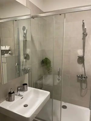 a bathroom with a sink and a glass shower at Iskra in Karaburma