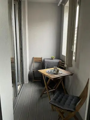 a small table and chairs in a small room with a table at Iskra in Karaburma