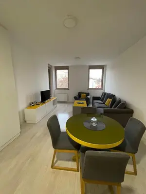 a living room with a couch and a table at Iskra in Karaburma