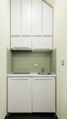 a kitchen with white cabinets and a sink at Old Port Lux RiverView Duplex in City Center in Belgrade