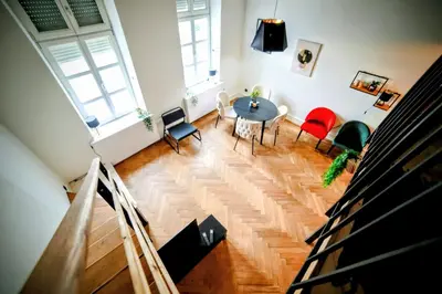 a living room with a table and chairs at Old Port Lux RiverView Duplex in City Center in Belgrade