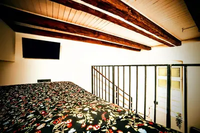 a bedroom with a bed and a tv on a balcony at Old Port Lux RiverView Duplex in City Center in Belgrade