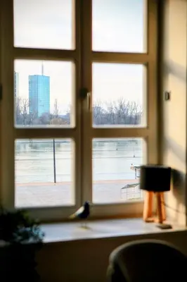a window with a view of a city seen through it at Old Port Lux RiverView Duplex in City Center in Belgrade