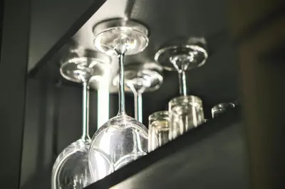 a row of wine glasses sitting on a shelf at Old Port Lux RiverView Duplex in City Center in Belgrade
