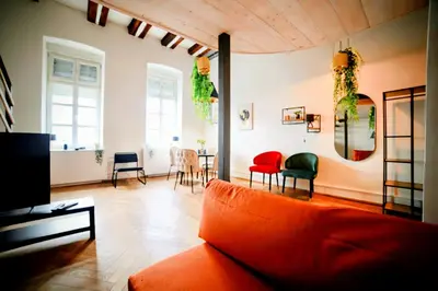 a living room with an orange couch and chairs at Old Port Lux RiverView Duplex in City Center in Belgrade