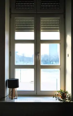 a window with doors in a room with a chair at Old Port Lux RiverView Duplex in City Center in Belgrade