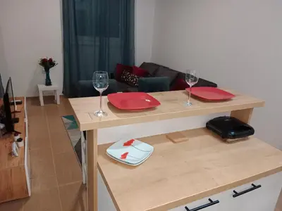 a table with two red plates and wine glasses at Apartman KLM in Pančevo