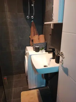 a small bathroom with a sink and a toilet at Apartman KLM in Pančevo