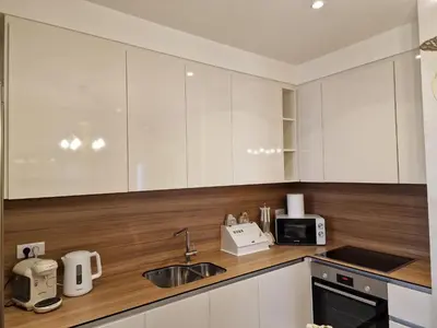 a kitchen with white cabinets and a sink at Beograd na Vodi - BW ARCADIA LUXURY in Belgrade