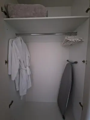 a closet with a white shirt and a tie at Beograd na Vodi - BW ARCADIA LUXURY in Belgrade