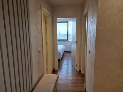 a hallway with a room with a bed and a window at Beograd na Vodi - BW ARCADIA LUXURY in Belgrade