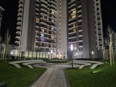 a park in front of two tall buildings at night at Beograd na Vodi - BW ARCADIA LUXURY in Belgrade