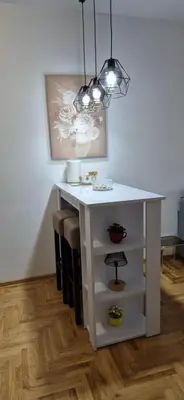 a white table in a room with a light at Fimiso in Borča