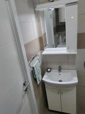 a small bathroom with a sink and a mirror at Fimiso in Borča