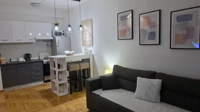 a living room with a couch and a kitchen at Fimiso in Borča