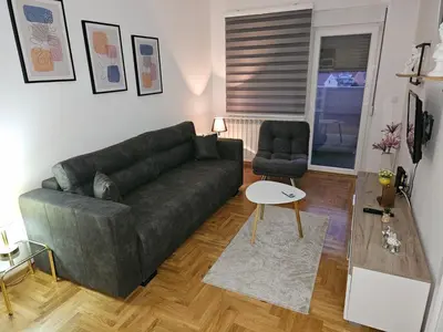 a living room with a couch and a chair at Fimiso in Borča