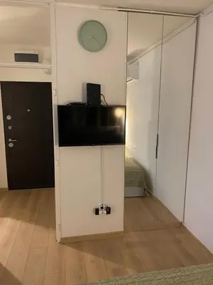 a room with a mirror and a clock on the wall at Smart lux in Tošin Bunar