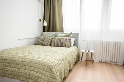 a bedroom with a bed and a side table at Smart lux in Tošin Bunar