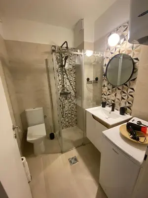 a bathroom with a shower and a toilet and a sink at Smart lux in Tošin Bunar