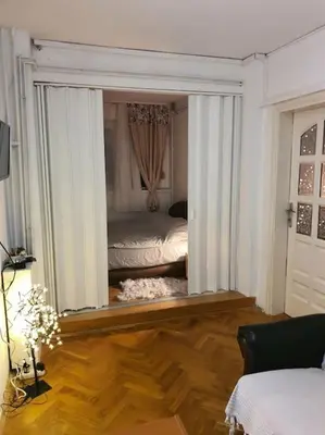 a room with a bedroom with a bed and a mirror at Sunflower apartment in Žarkovo