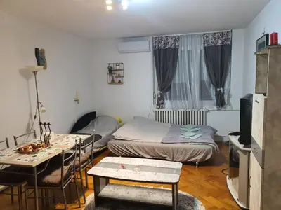 a small room with a bed and a table and chairs at Sunflower apartment in Žarkovo