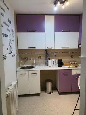a kitchen with purple and white cabinets and a sink at Sunflower apartment in Žarkovo
