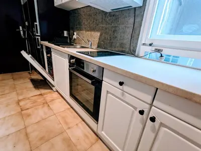 a white kitchen with a sink and a stove at Boba FREE PARKING in Zvezdara