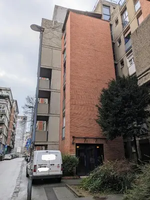 a white van parked in front of a brick building at Boba FREE PARKING in Zvezdara