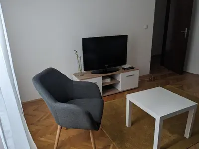 a living room with a chair and a television at Boba FREE PARKING in Zvezdara