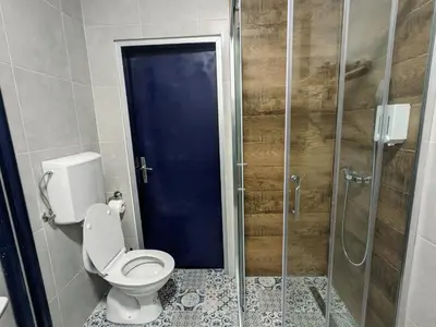 a bathroom with a toilet and a glass shower at Boba FREE PARKING in Zvezdara