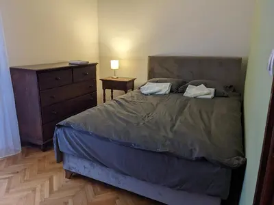a bedroom with a bed with a dresser and a night stand at Deja FREE PARKING in Zvezdara
