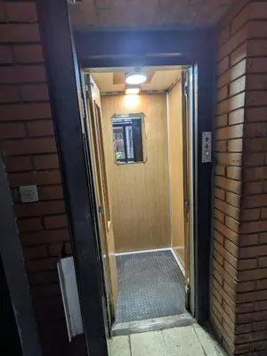 a hallway leading to a door in a building at Deja FREE PARKING in Zvezdara