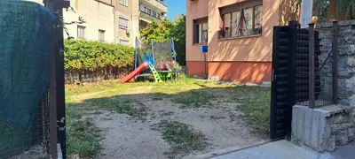 an open gate to a yard with a playground at Deja FREE PARKING in Zvezdara