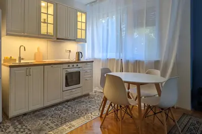 a kitchen with a table and chairs and a sink at Deja FREE PARKING in Zvezdara