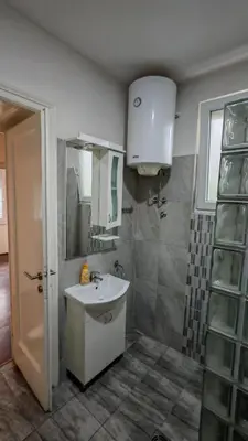 a bathroom with a sink and a mirror at ZELENI VENAC Studio & Apartment in Belgrade