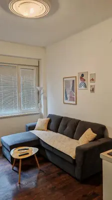 a living room with a couch and a table at ZELENI VENAC Studio & Apartment in Belgrade
