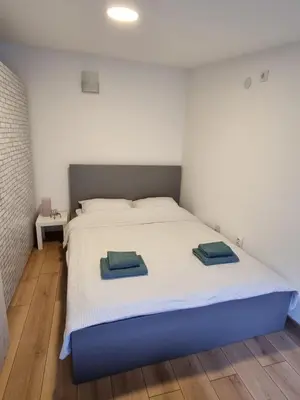 a bedroom with a bed with two towels on it at Apartment S in Belgrade